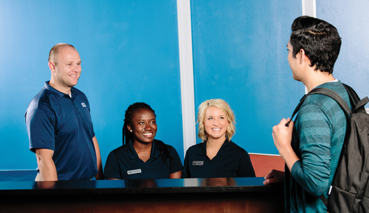 Canadian Campus Communities employees helping a student resident.